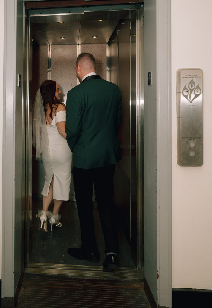Bride and groom posing in the elevator for their Philadelphia City Hall wedding photos