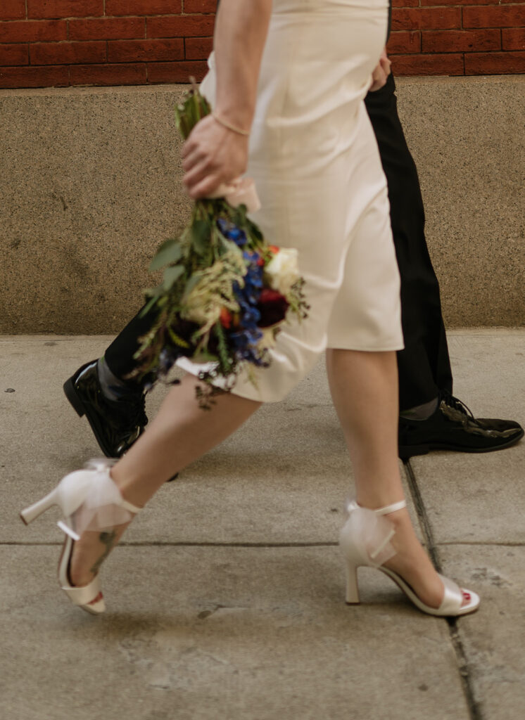 Close up shot of a bride and groom walking together in downtown Philadelphia