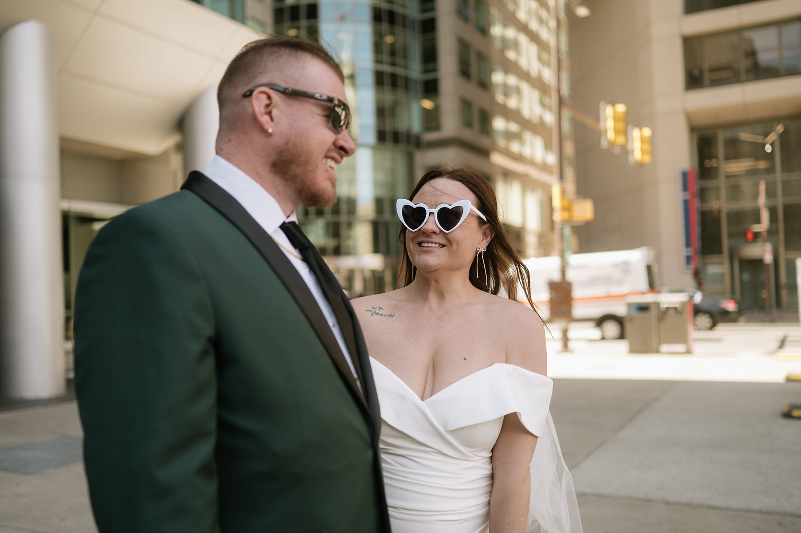 Bride and groom posing for their downtown Philadelphia elopement photos wearing sunglasses