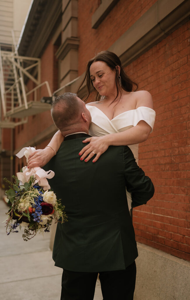 Groom picking up his bride during their Philadelphia elopement photos