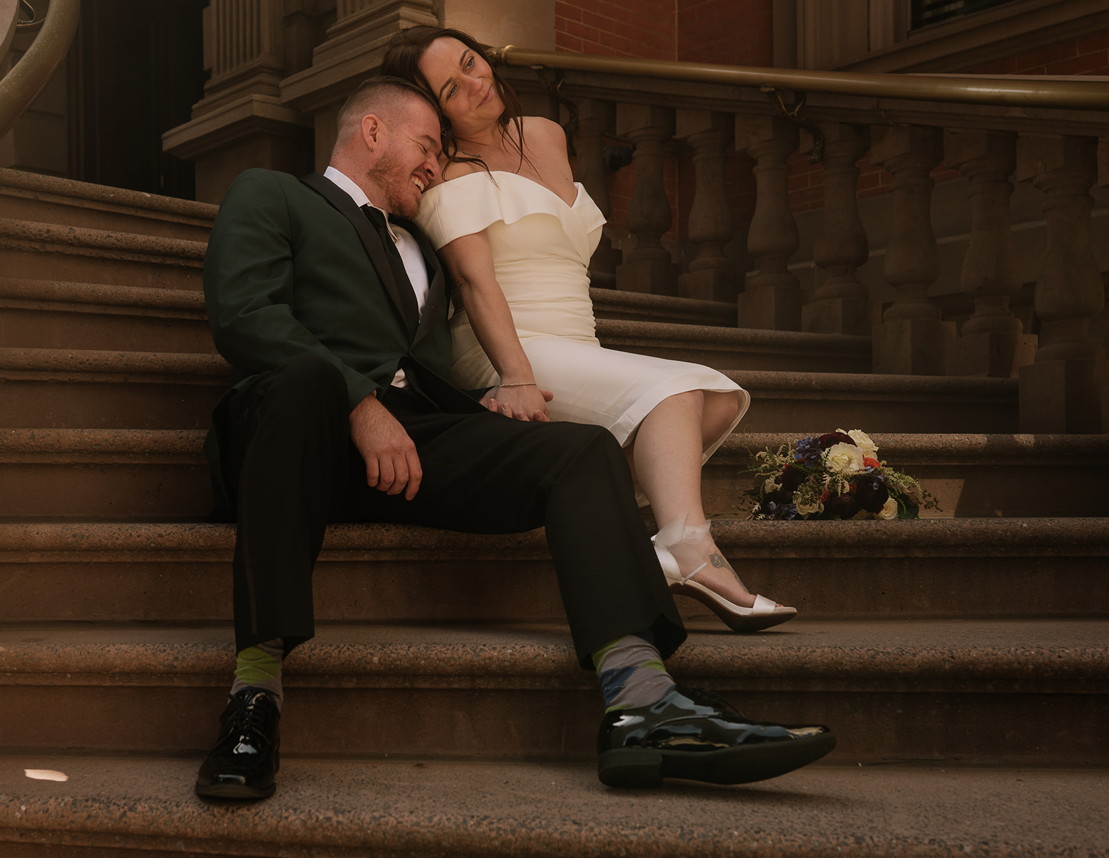 Bride and groom sitting on the stairs in PA Town for their Philadelphia elopement photos