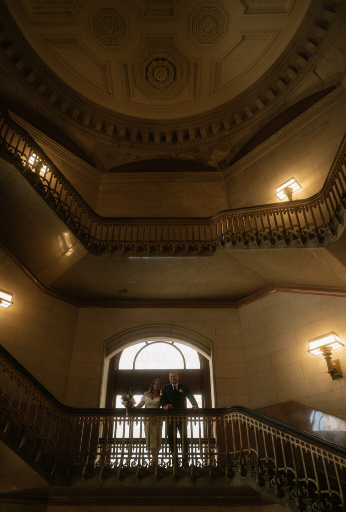 Bride and groom posing on the staircase for their Philadelphia City Hall wedding