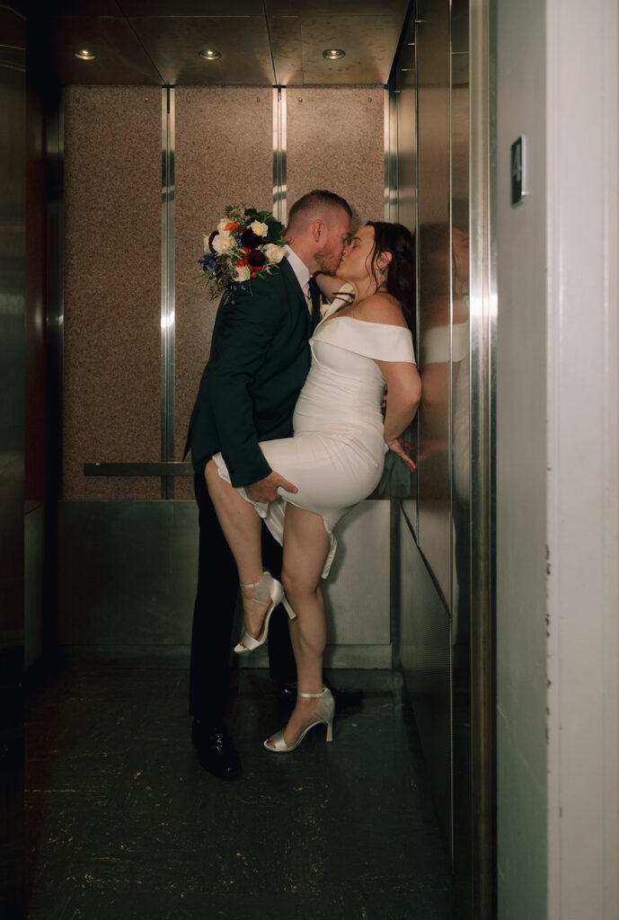 Bride and groom kissing in the elevator for their Philadelphia City Hall wedding