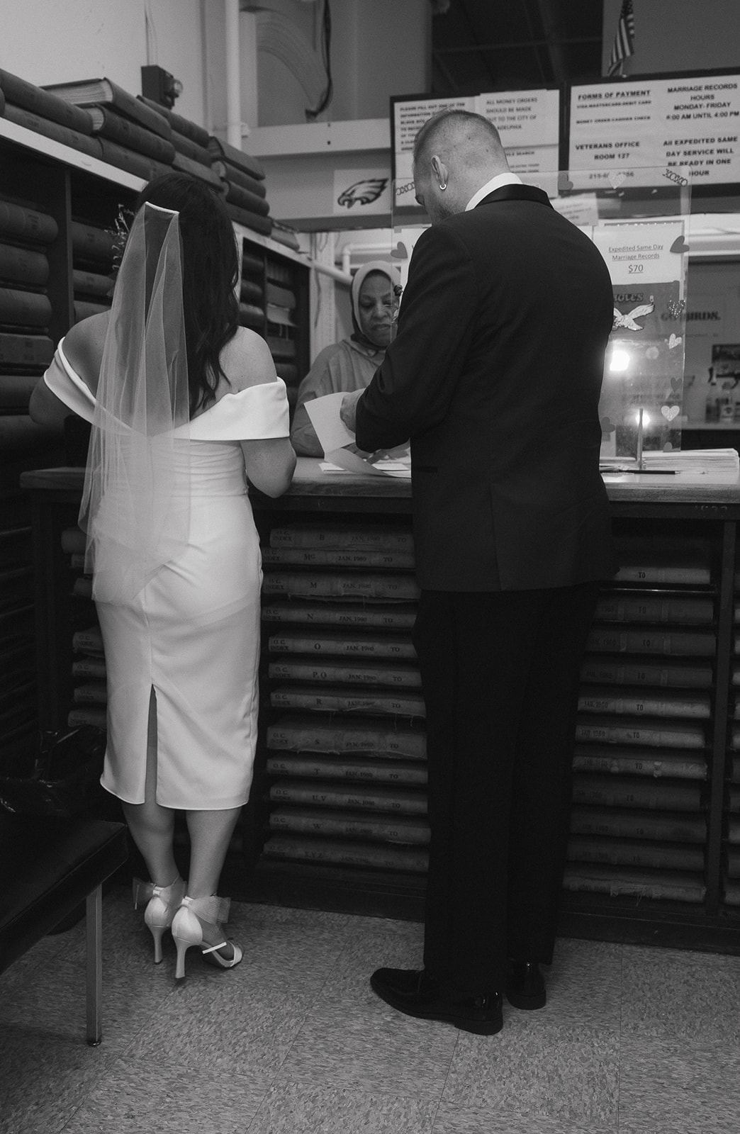 Bride and groom doing paperwork for their Philadelphia City Hall wedding