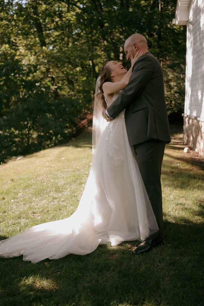 Bride and groom laughing together during their wedding at The Inn at Millrace Pond wedding venue