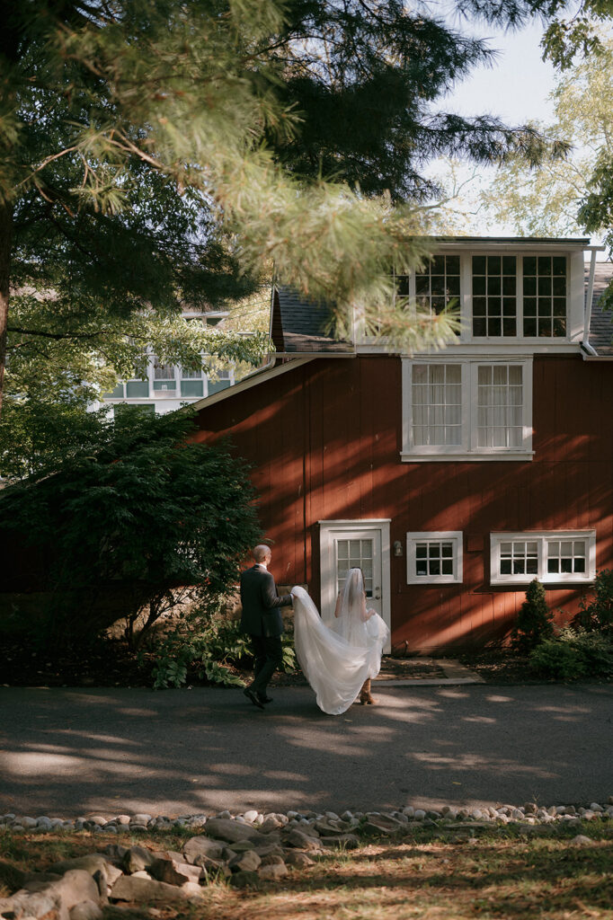 Bride and groom walking outside of The Inn at Millrace Pond wedding venue
