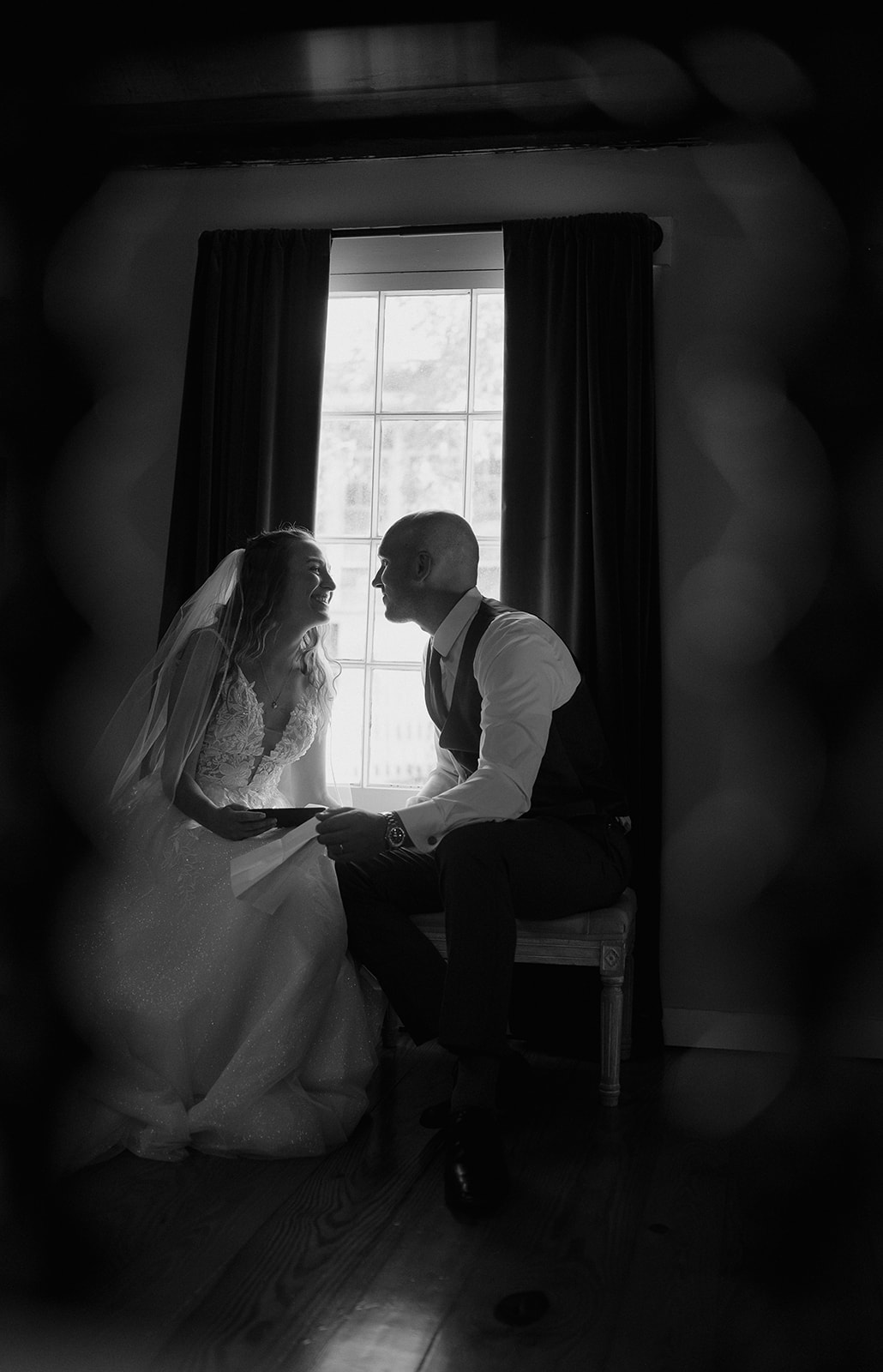 Black and white photo of a bride and groom sharing private vows to one another - storytelling wedding photography
