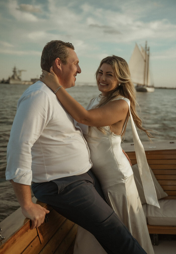 Woman smiling at the camera during her sunset boat engagement session