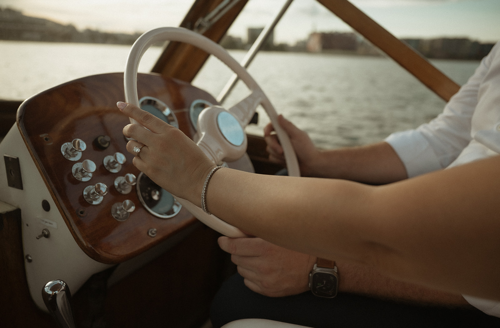 Couple steering The Argonaut together during their romantic engagement session on the water in Philadelphia.