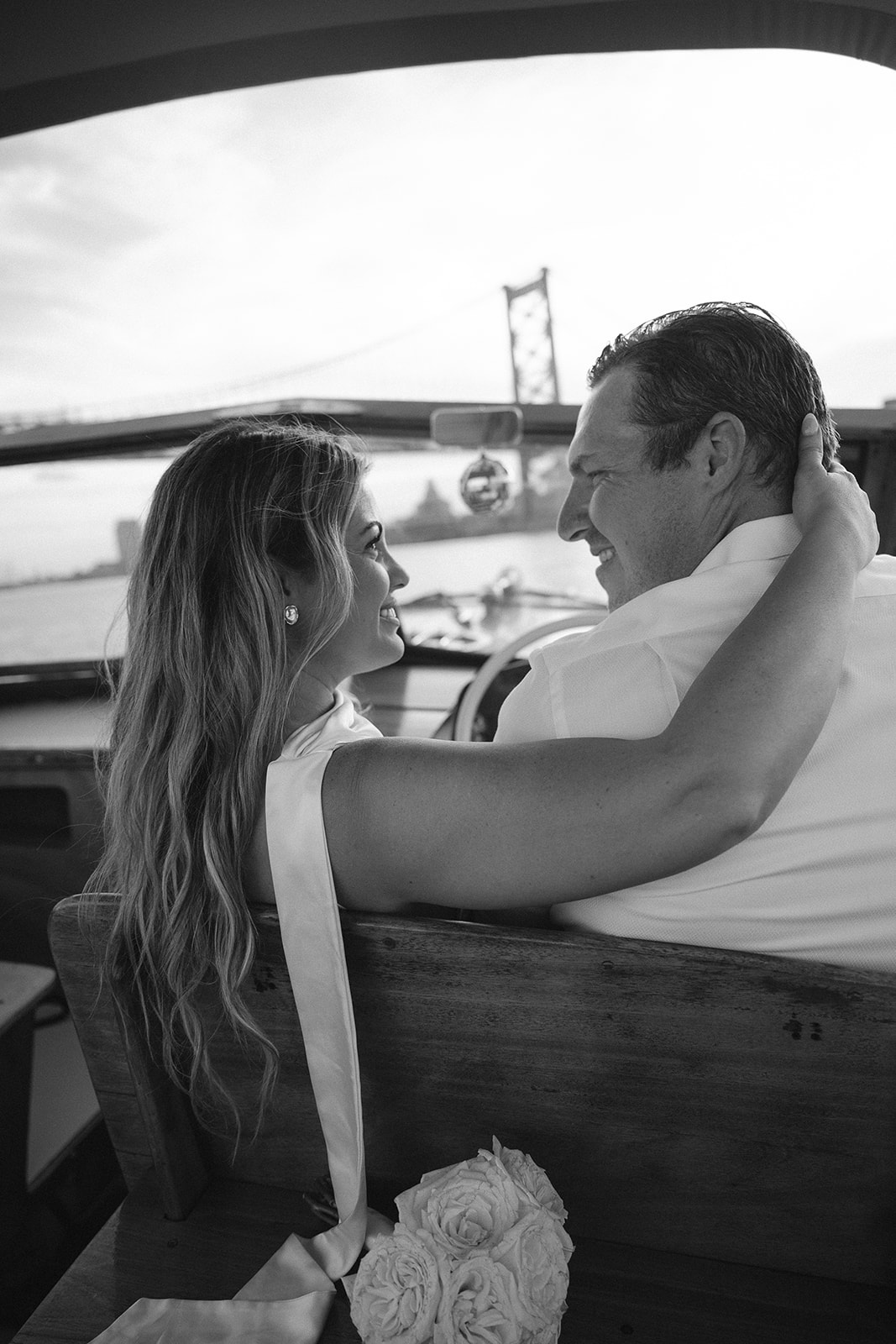 Black and white photo of Nicole and Chris smiling at each other during their Sea Philly engagement session.