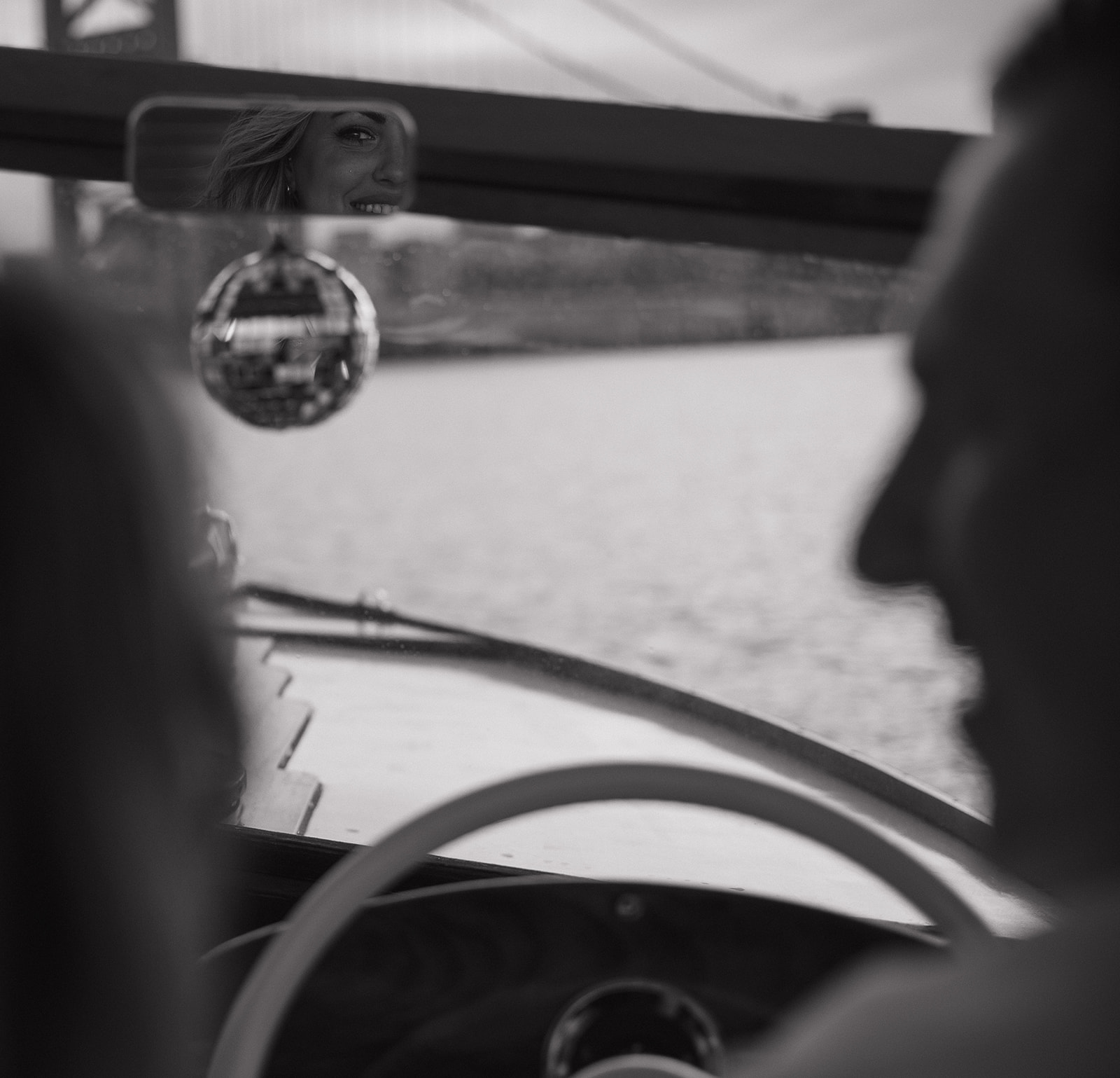 Black and white photo of a couple on the Argonaut with Sea Philly during a golden sunset engagement session on the water.