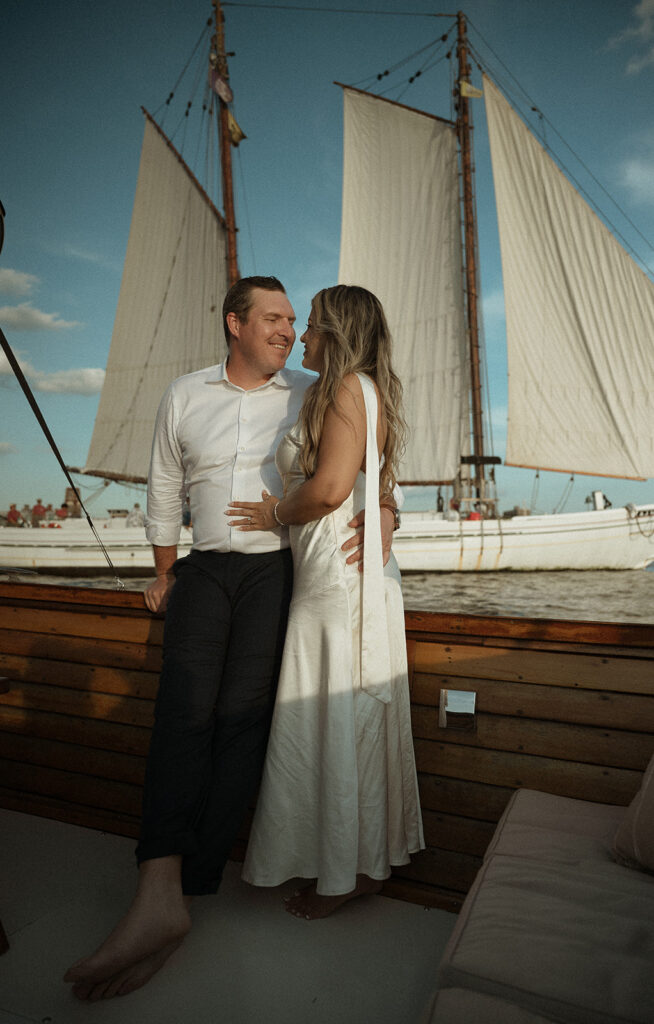 Man and woman posing on a boat in Philly for their engagement