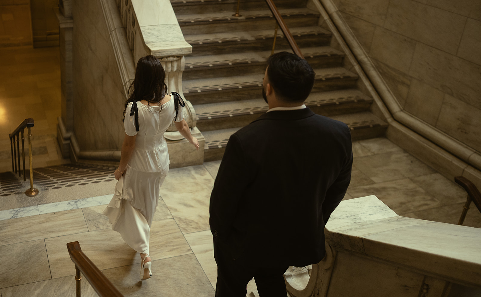 Couple walking down a staircase.