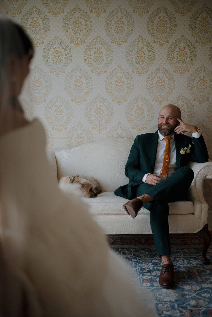Groom smiling at bride during intimate newlywed portrait inside Stone Acres Farm manor house.