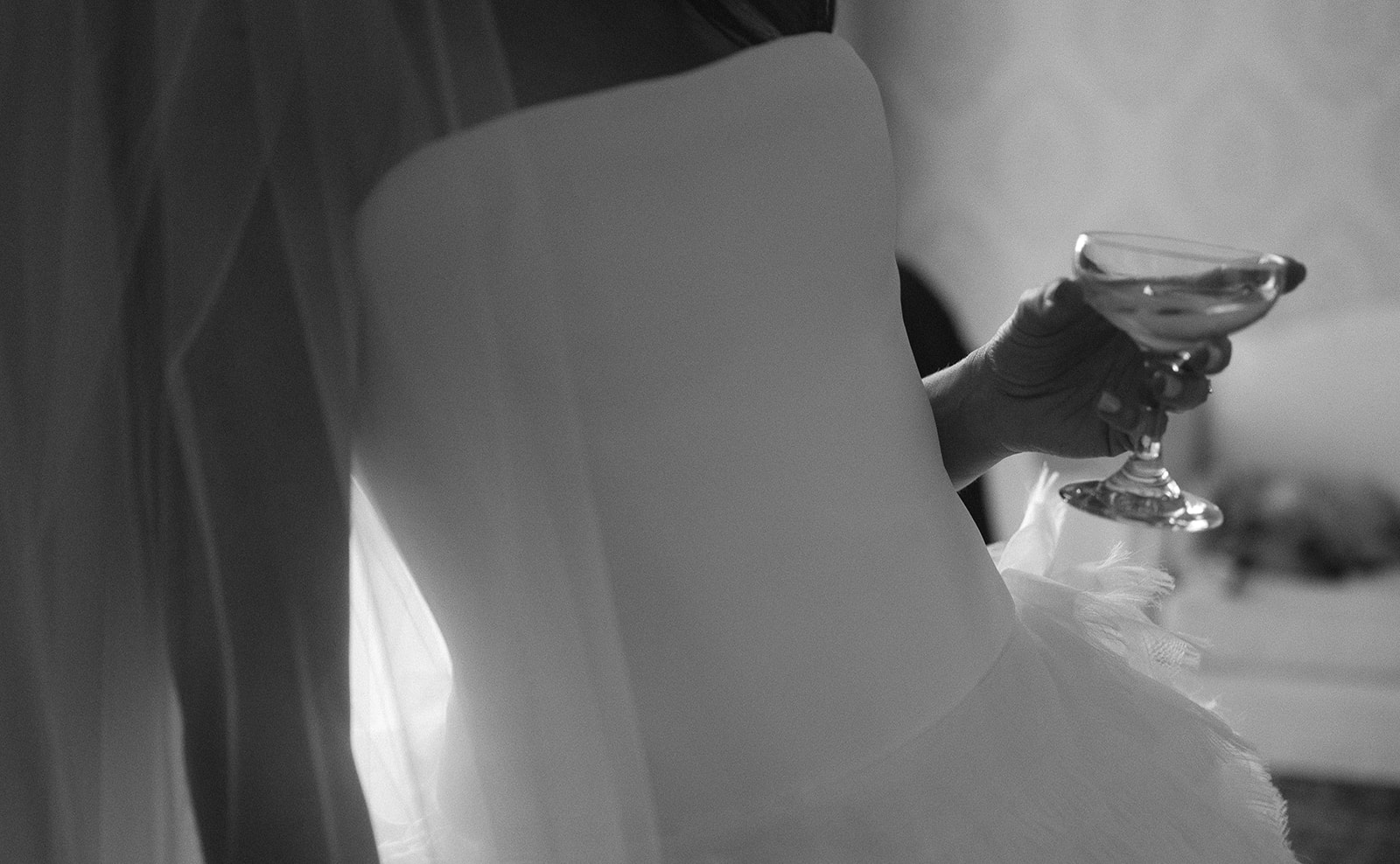 Close up of a bride holding a drink. 