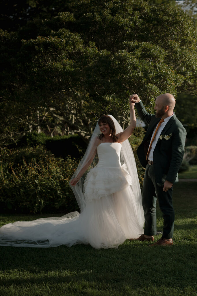 Couple sharing joyful moment during recessional after garden ceremony at Stone Acres Farm wedding.