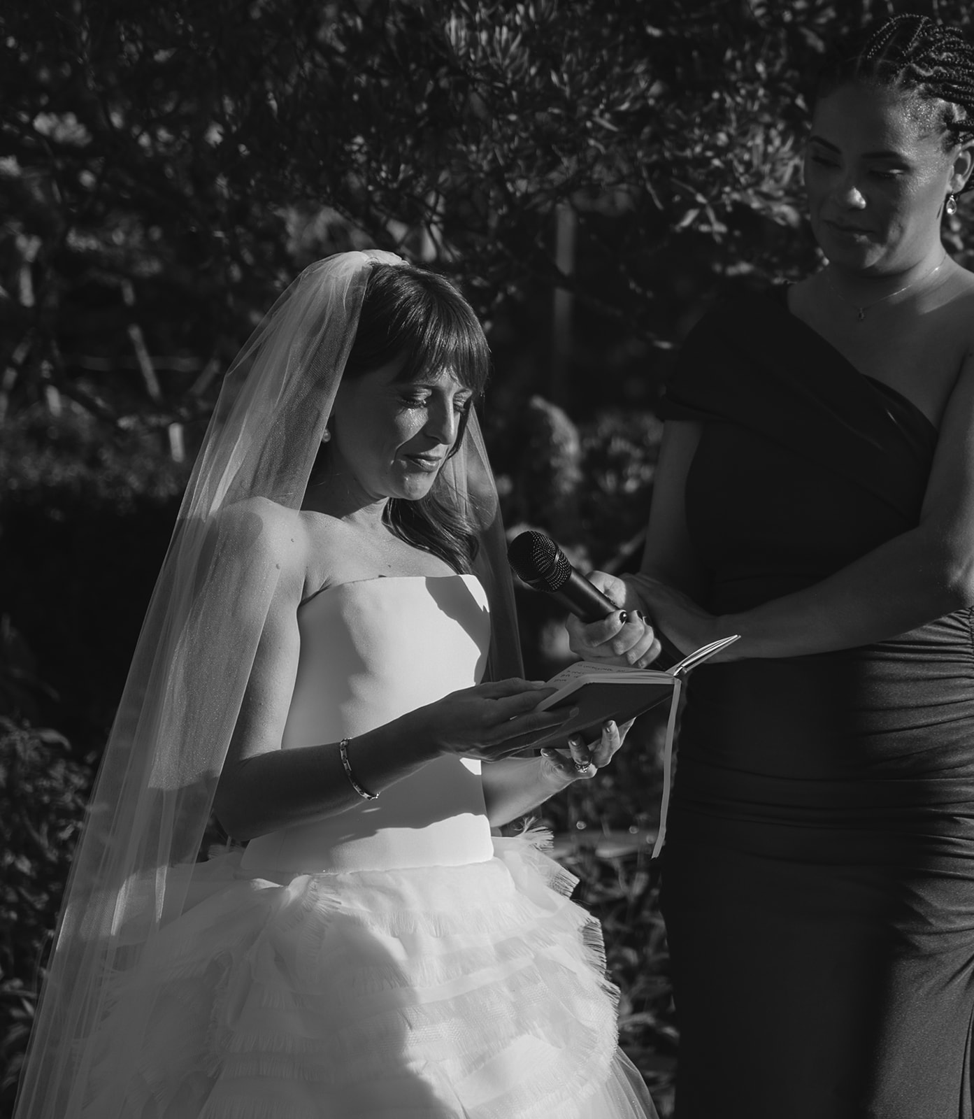 Close-up of bride reading vows during emotional outdoor ceremony at Stone Acres Farm wedding.