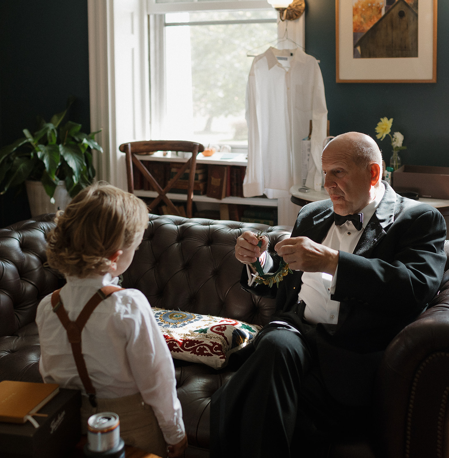 Guest helping a little boy get ready for a wedding day at Stone Acres Farm in Stonington, CT.