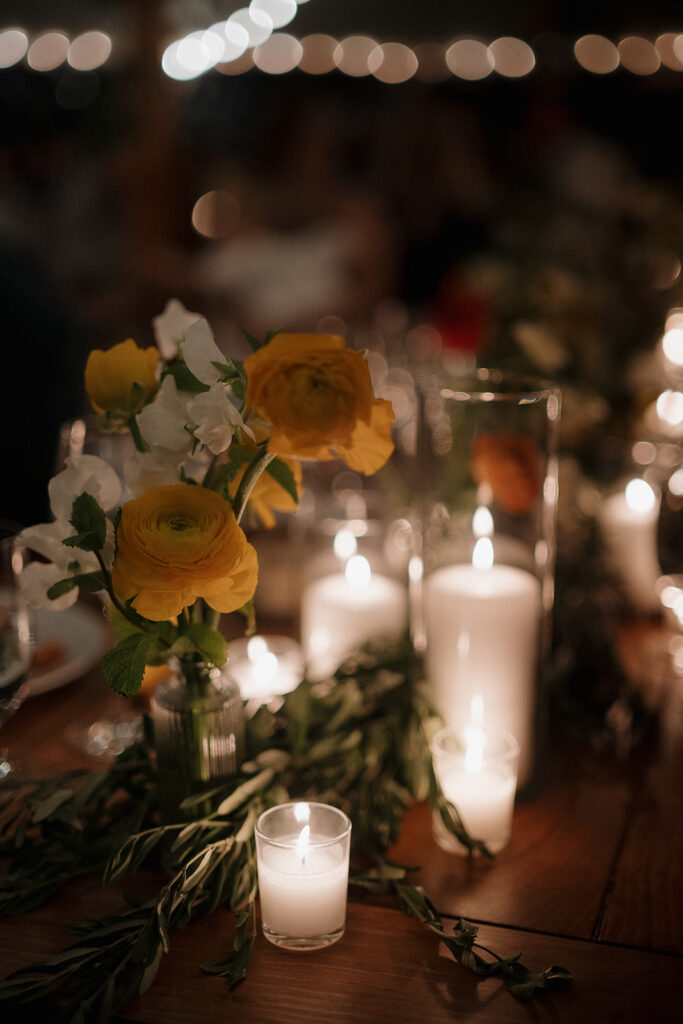 Wedding reception detail shot of a candlelit table.