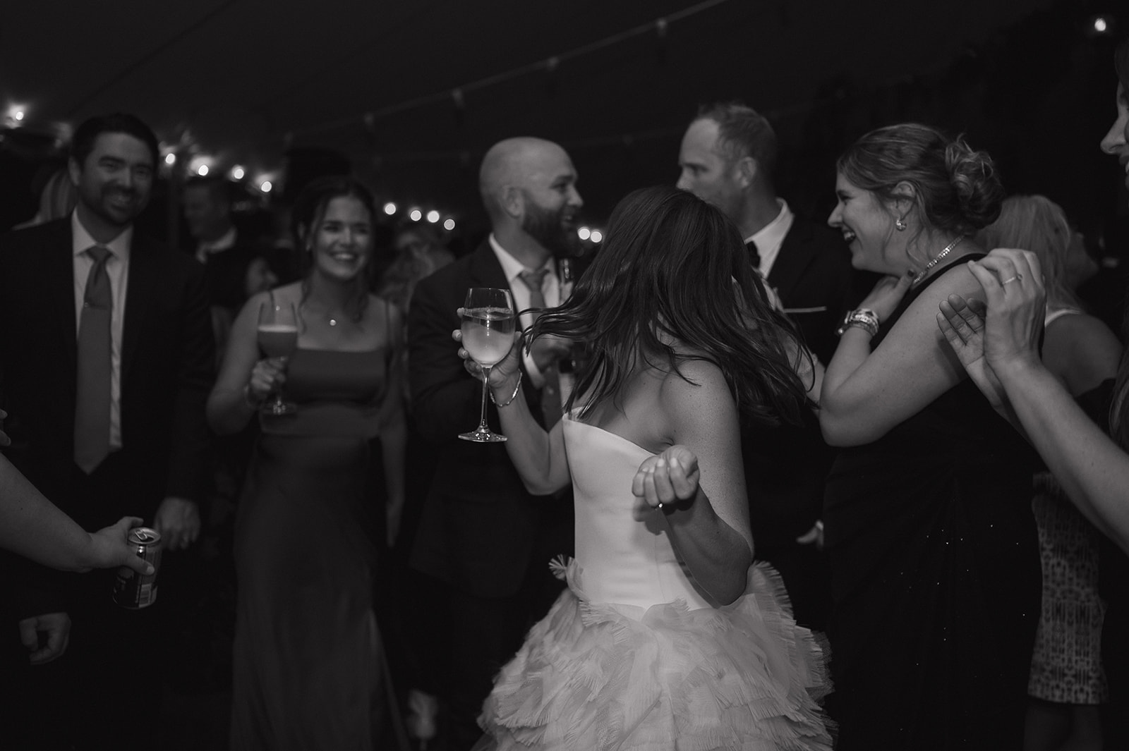 Bride dancing with guests on reception dance floor in The Meadow at Stone Acres Farm wedding.