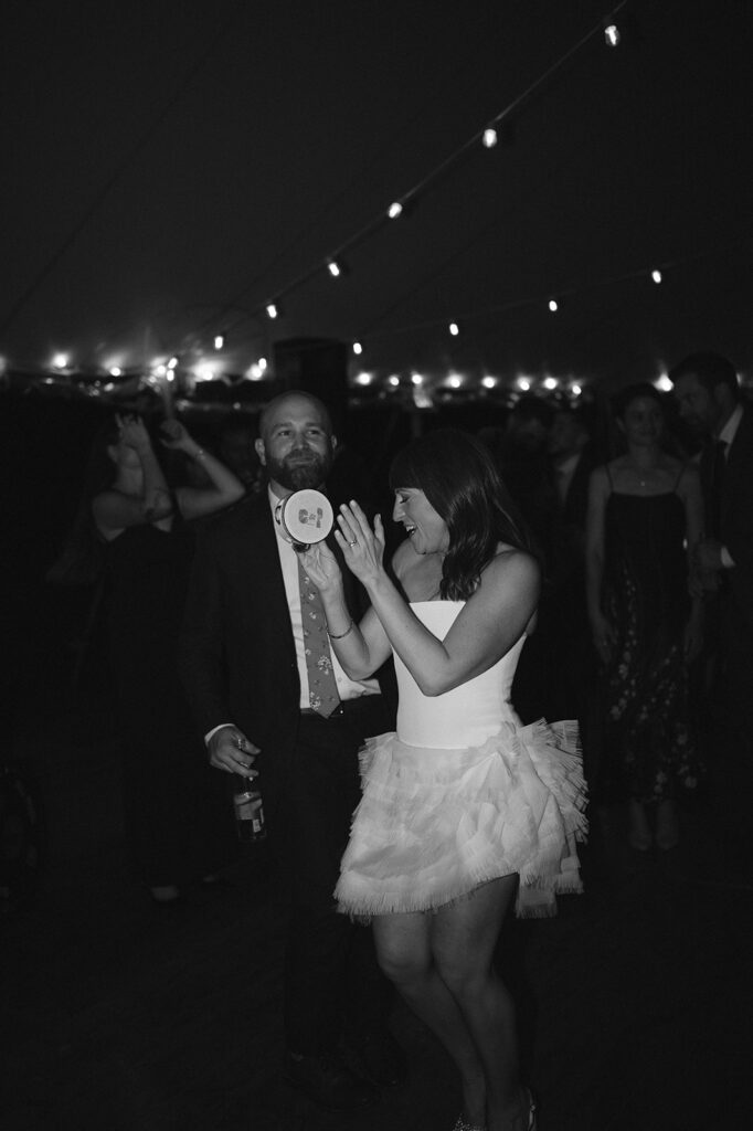 Black and white photo of a bride and groom dancing. 