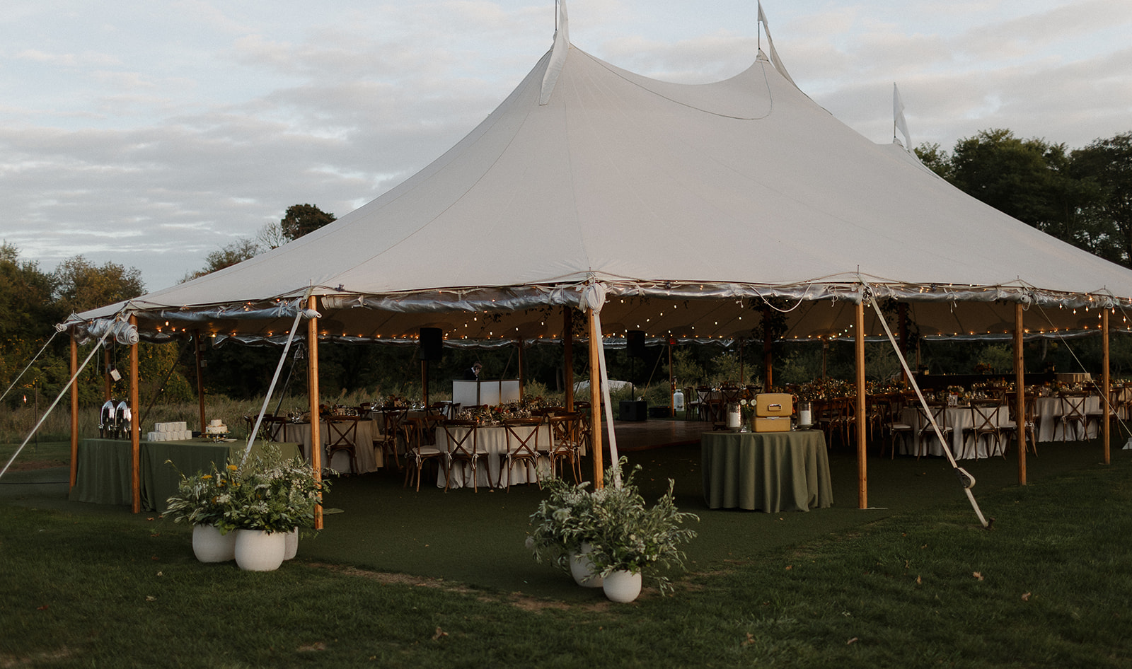 Wide view of tented reception pavilion in The Meadow at Stone Acres Farm wedding venue.