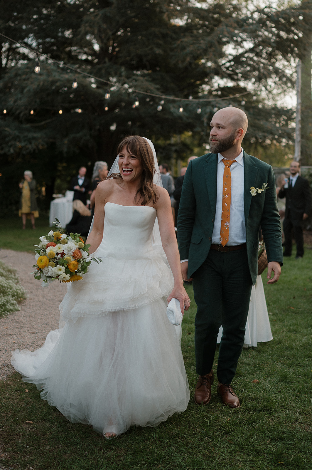 Bride and groom walking into their cocktail hour. 