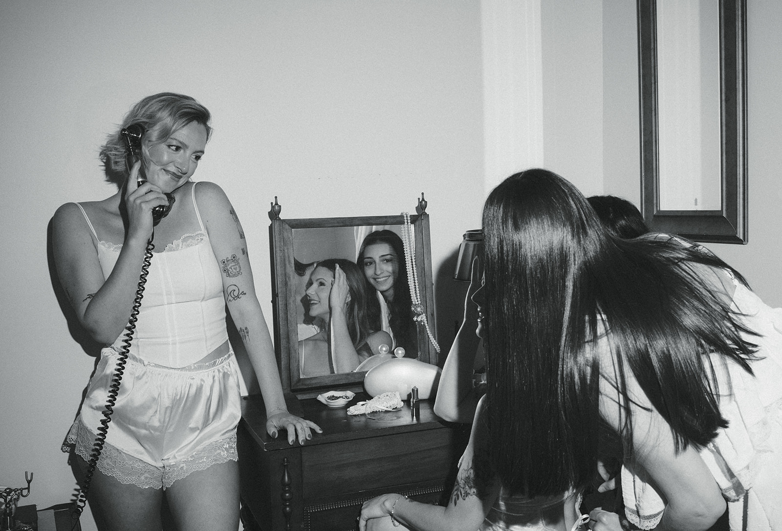 Black and white flash photo of a bride getting ready with her bridesmaids at Vaux Studio in Philadelphia.