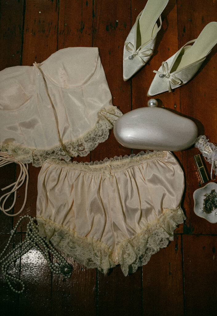 Close up shot of brides wedding details and getting ready outfit stled on a flat surface. 