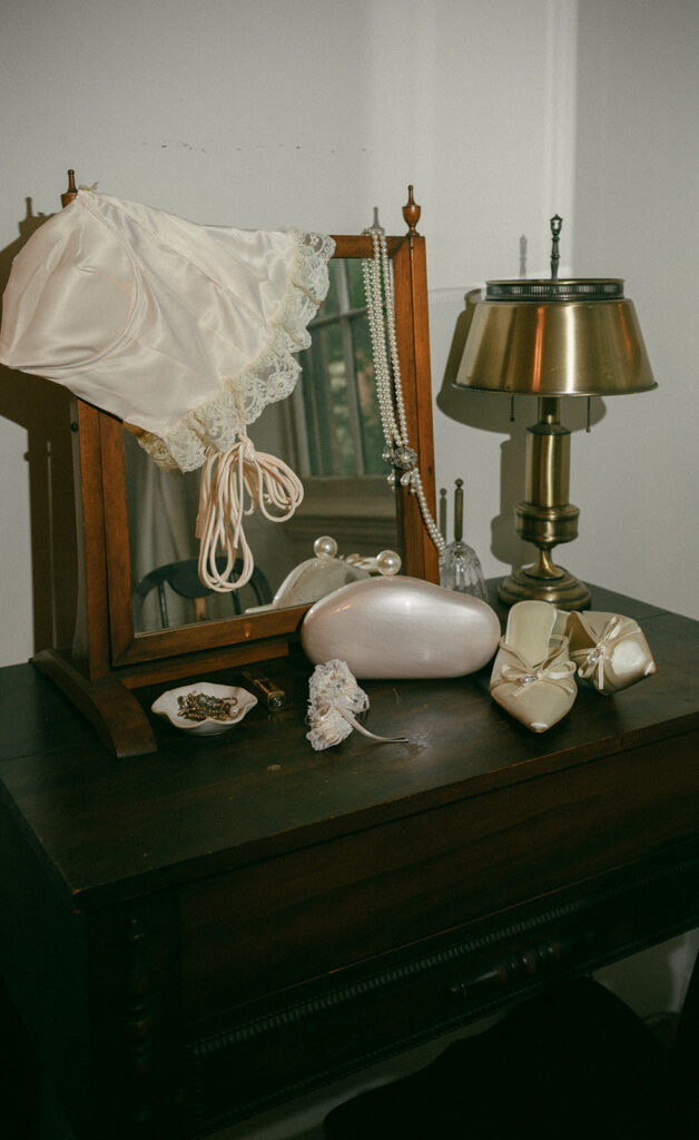 Brides details hanging on a vintage mirror for wedding detail shots.