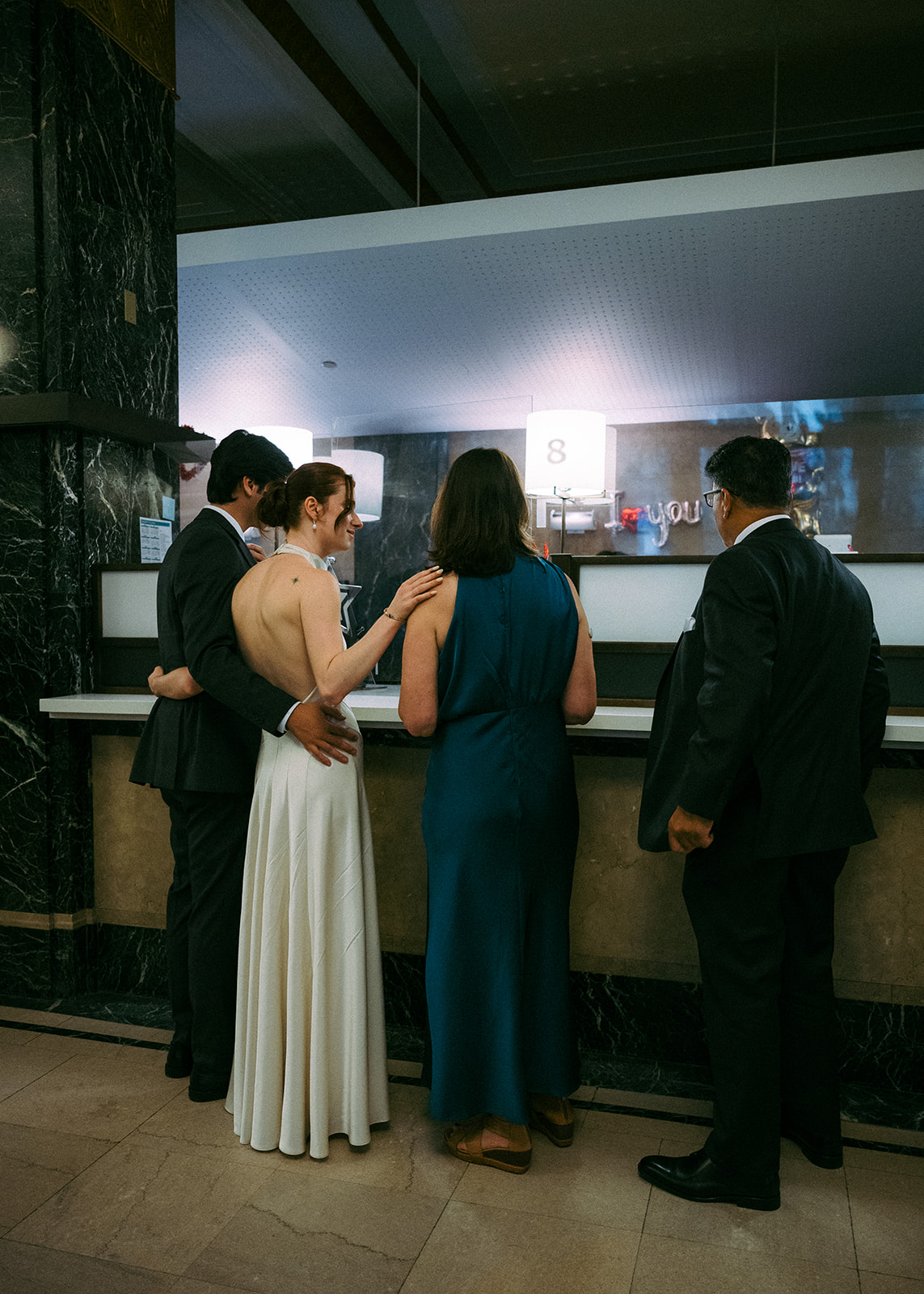 Bride and groom checking in for their NY City Hall elopement at the front desk. 