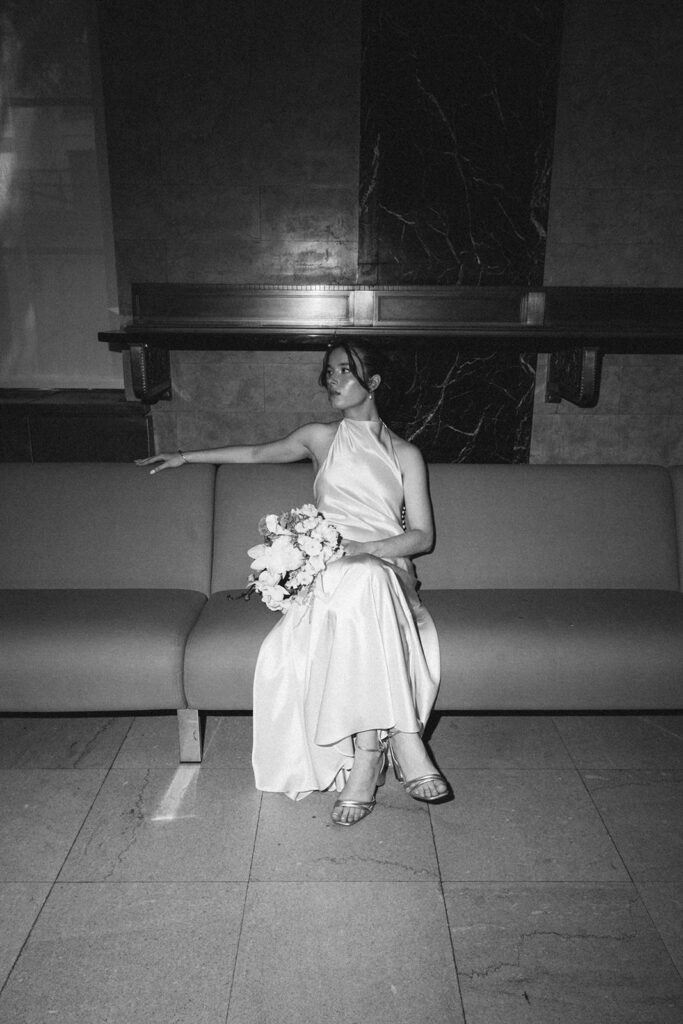 Black and white photo of a bride waiting for her NYC City Hall elopement. 