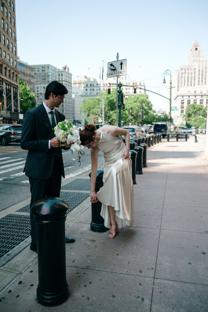 Bride and groom walking down the street in NYC.