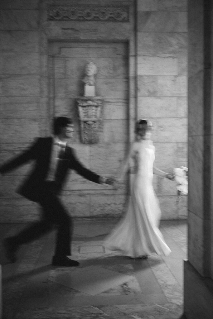 Motion blur photo of a couple running at The New York Public Library. 