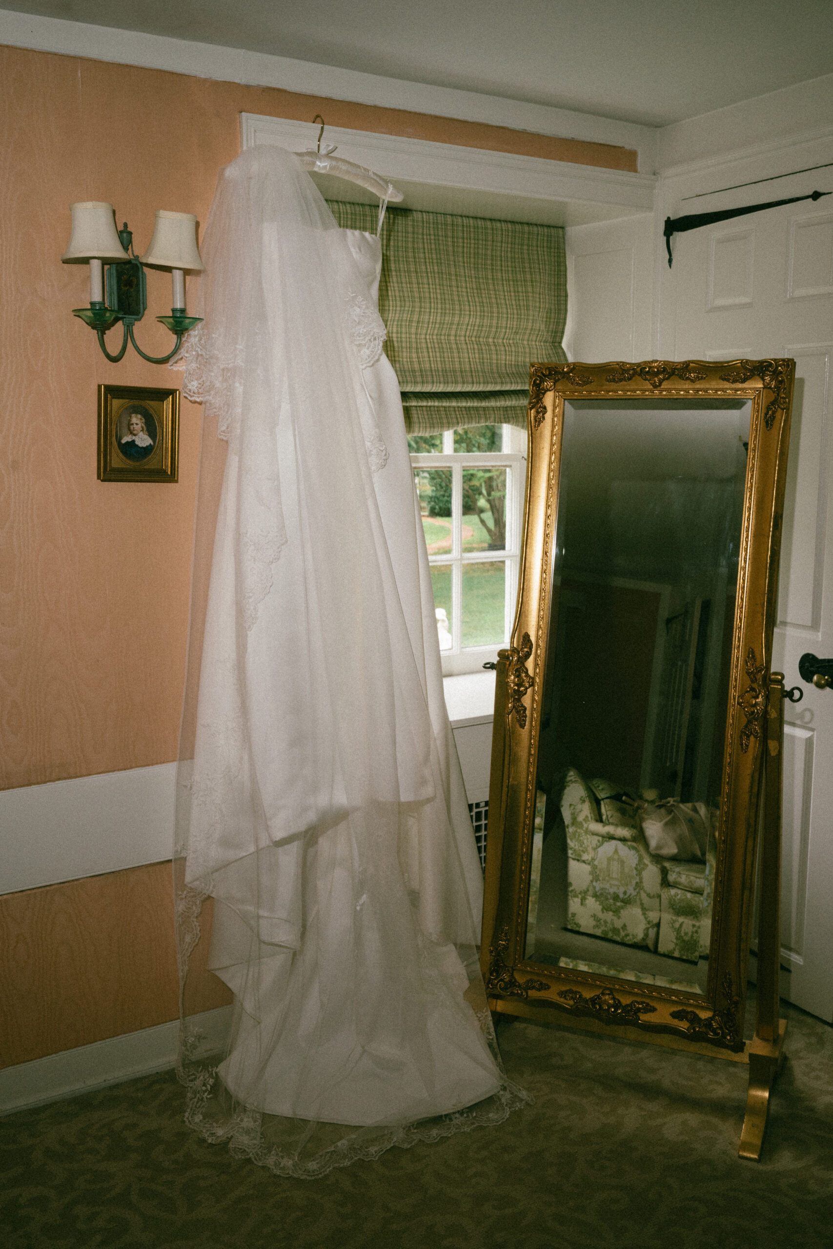 Wedding dress hanging in the vintage getting ready room at Appleford Estate in Villanova, PA
